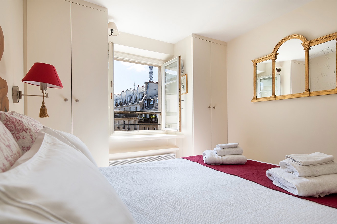 The romantic bedroom has views of the Eiffel Tower!