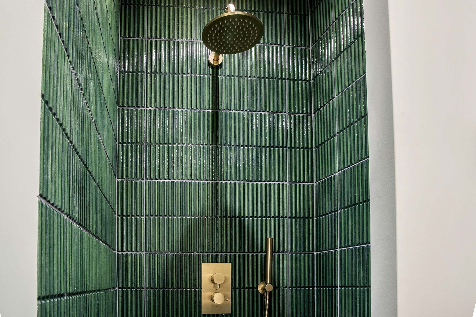 Gorgeous tiling with rainwater and handheld shower.