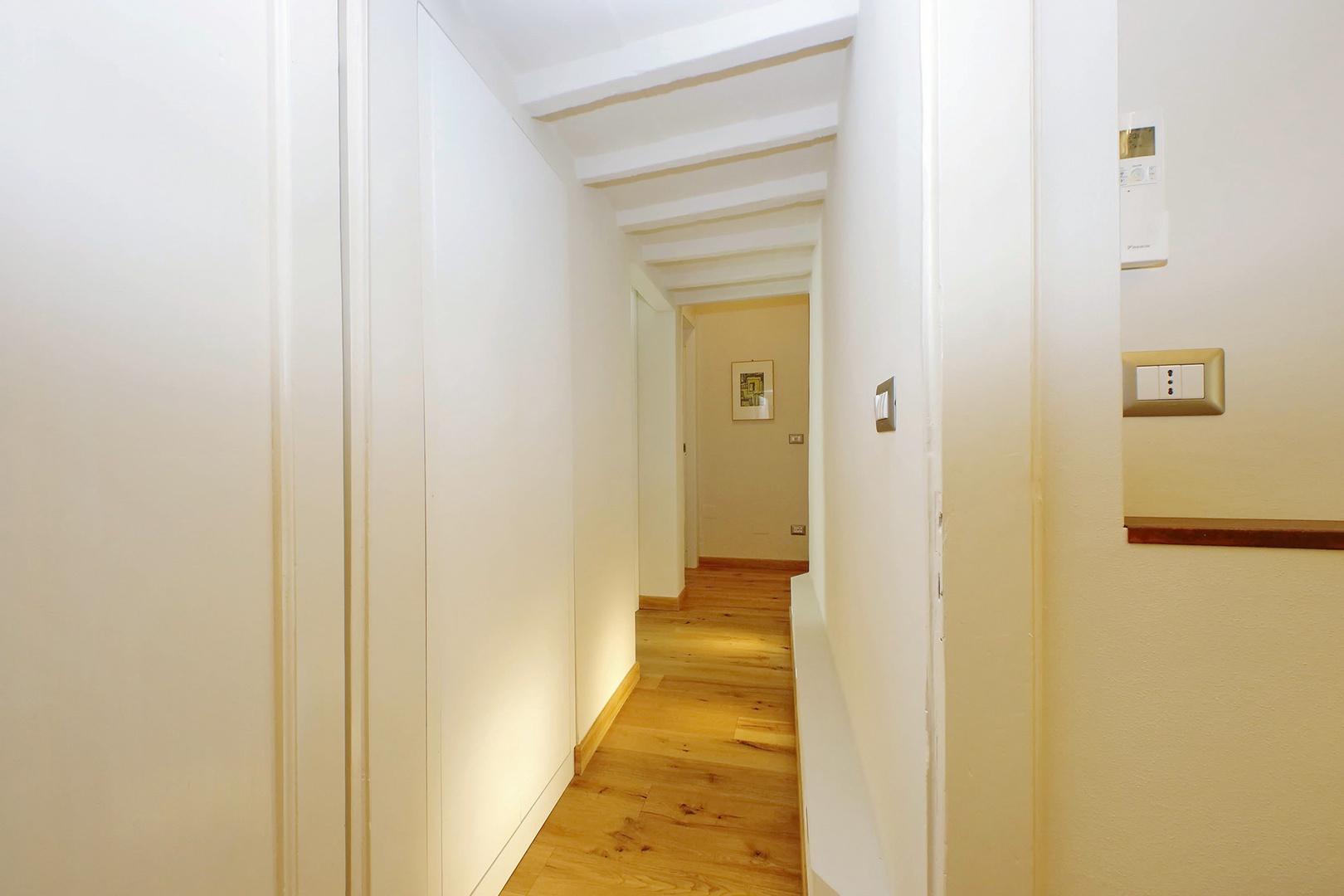 Bright hallway leading to both bedrooms.