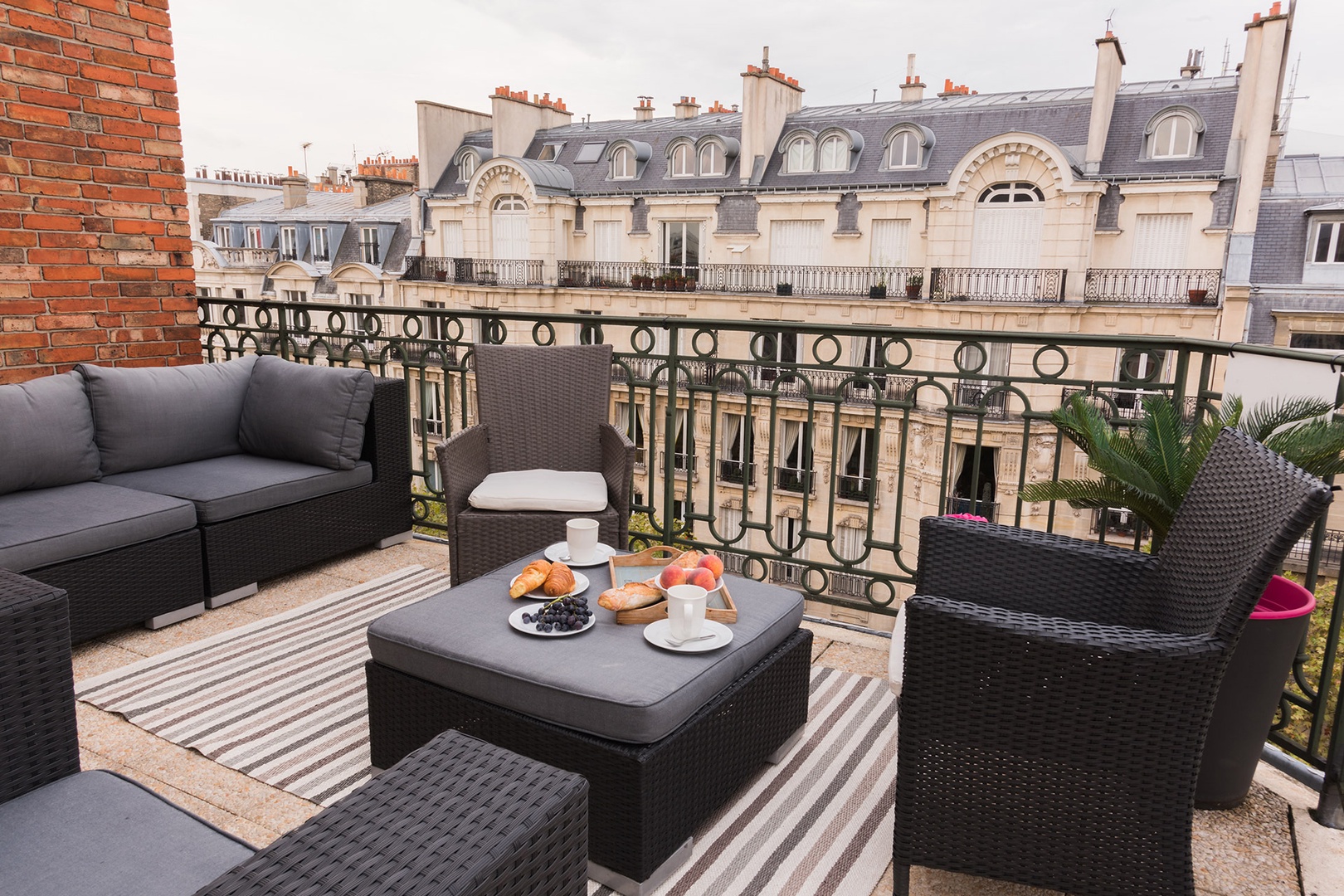 Lounge on the comfortable sofa and chairs as the sun sets over the rooftops of Paris.