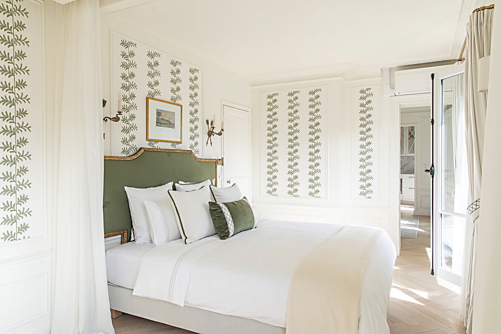 Delicate green wallpaper and antique details in bedroom.
