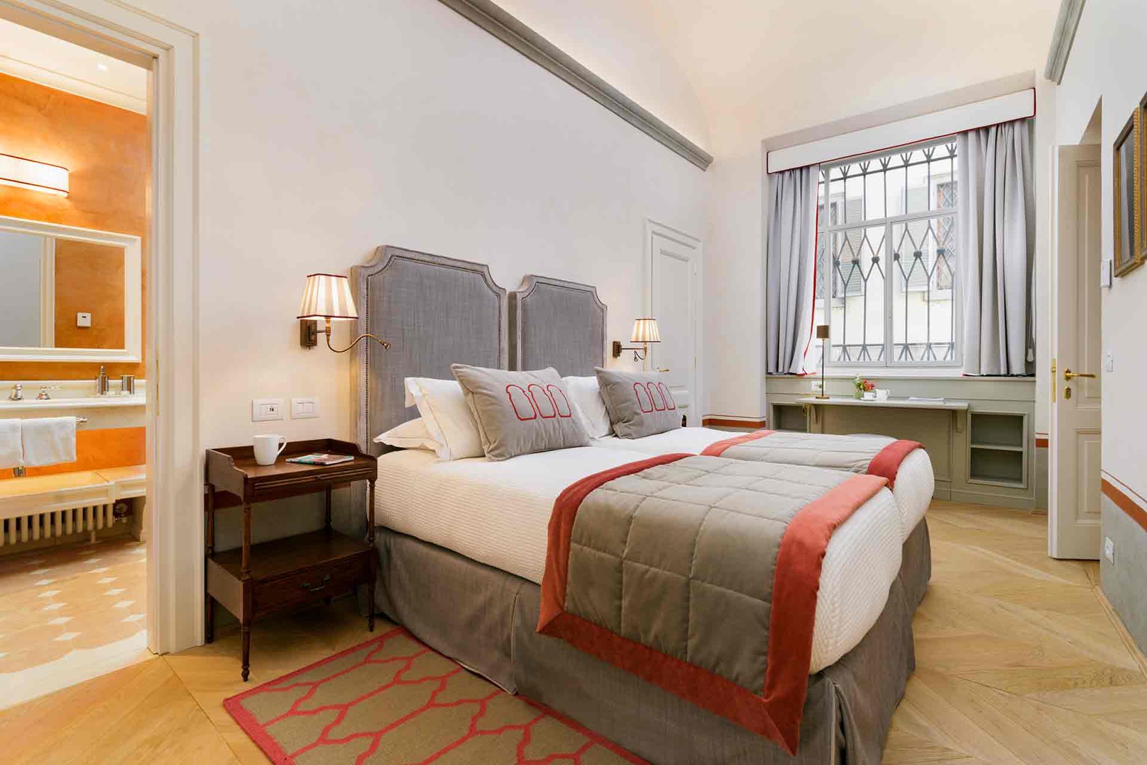 Bedroom 2 offers two beds dressed in soft linens and large window.