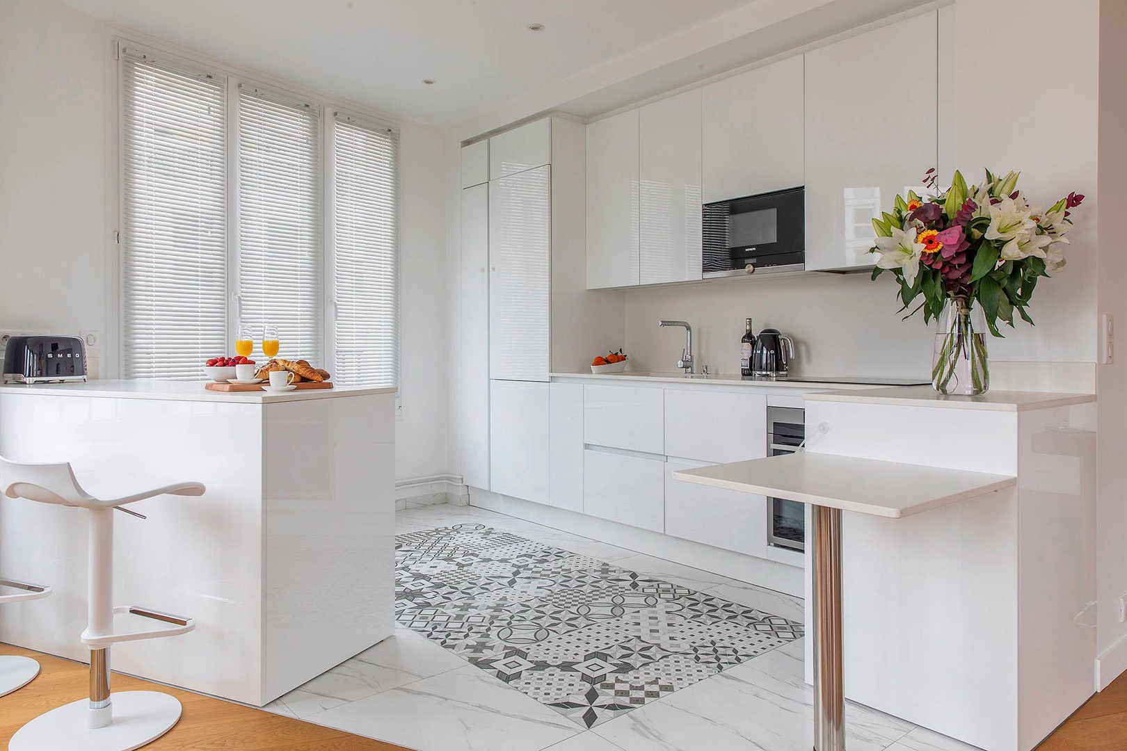 Spacious kitchen with sleek white cabinets.