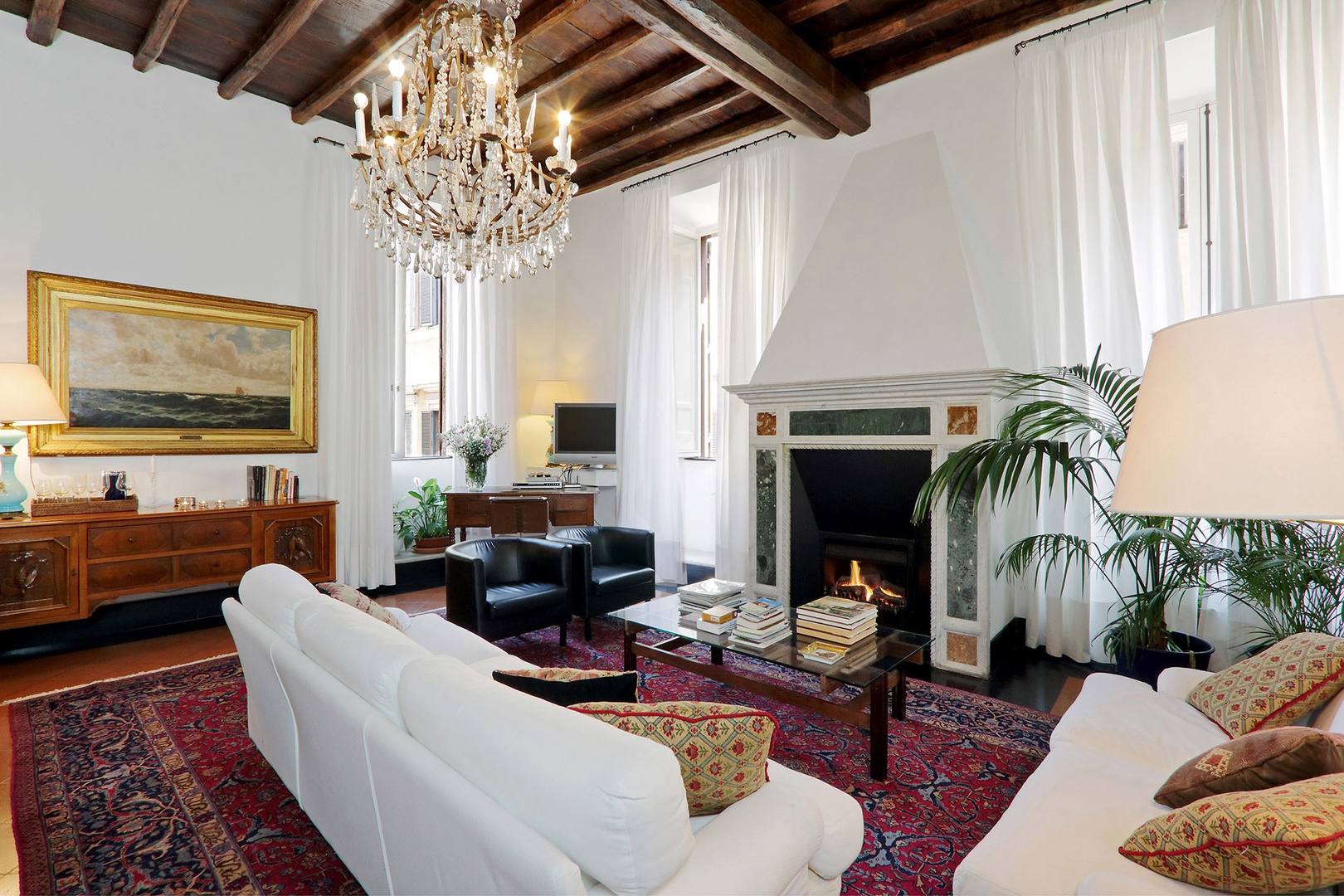 Large living room with a fireplace warms a chilly evening.