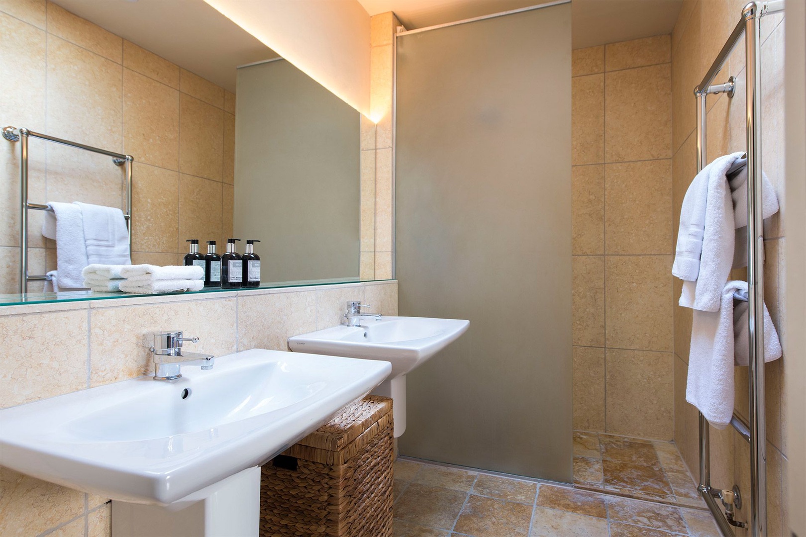 Spacious ensuite bathroom with shower, double sinks and toilet