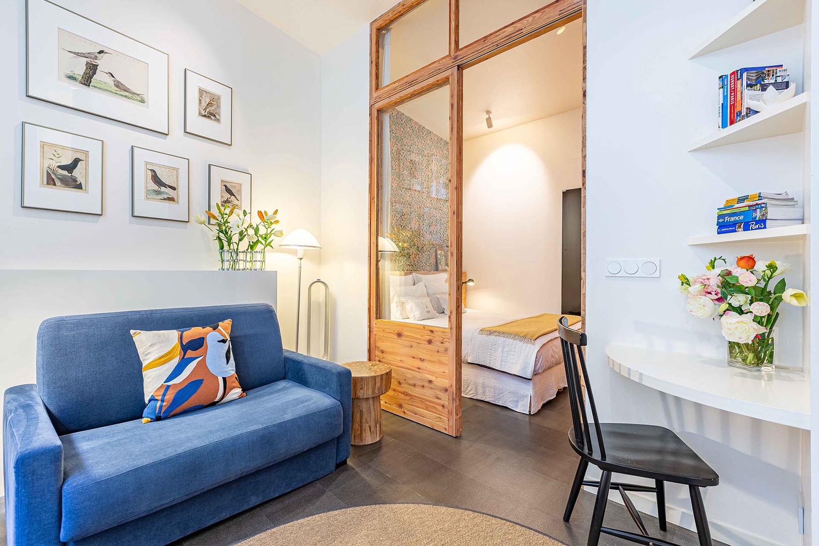 Light fills the bedroom through glass wall.