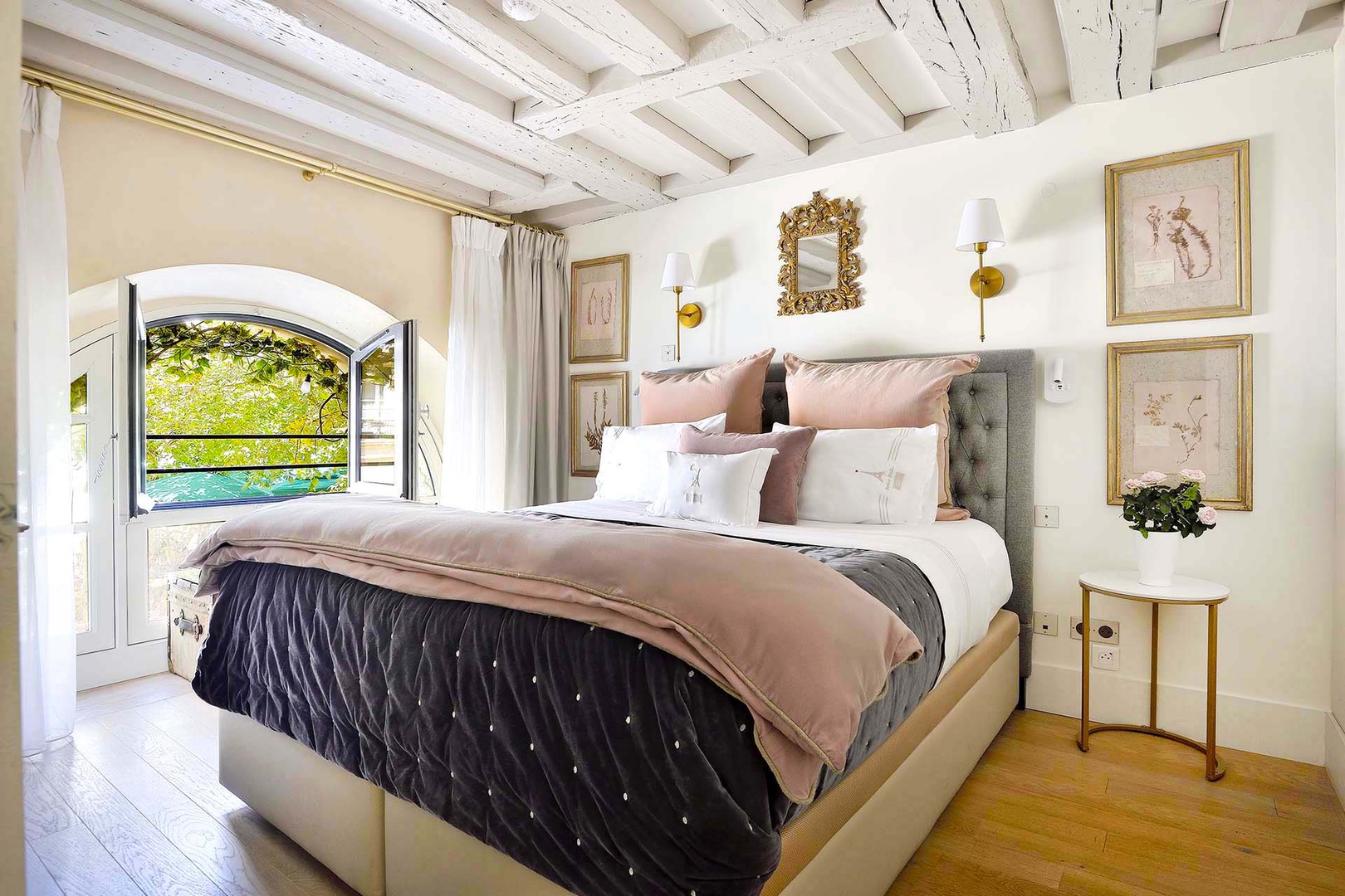 Bedroom 1 has historic details and a charming Place Dauphine view.