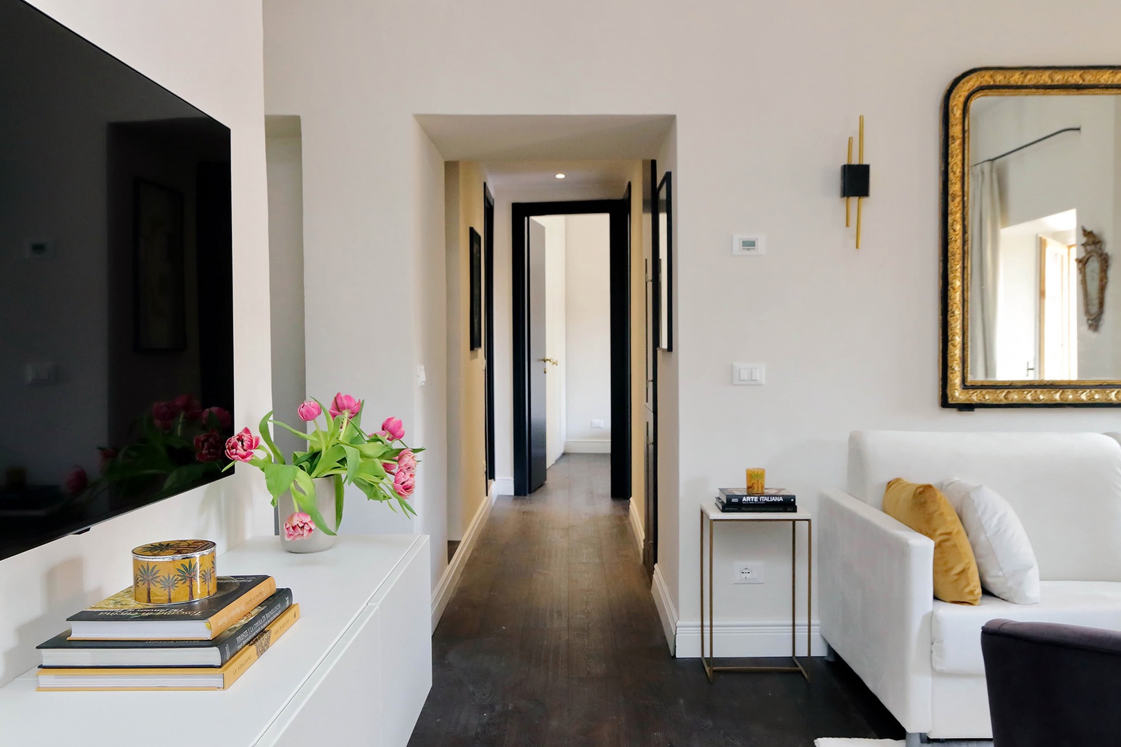 The spacious hallway leads to the bedrooms and bathrooms.