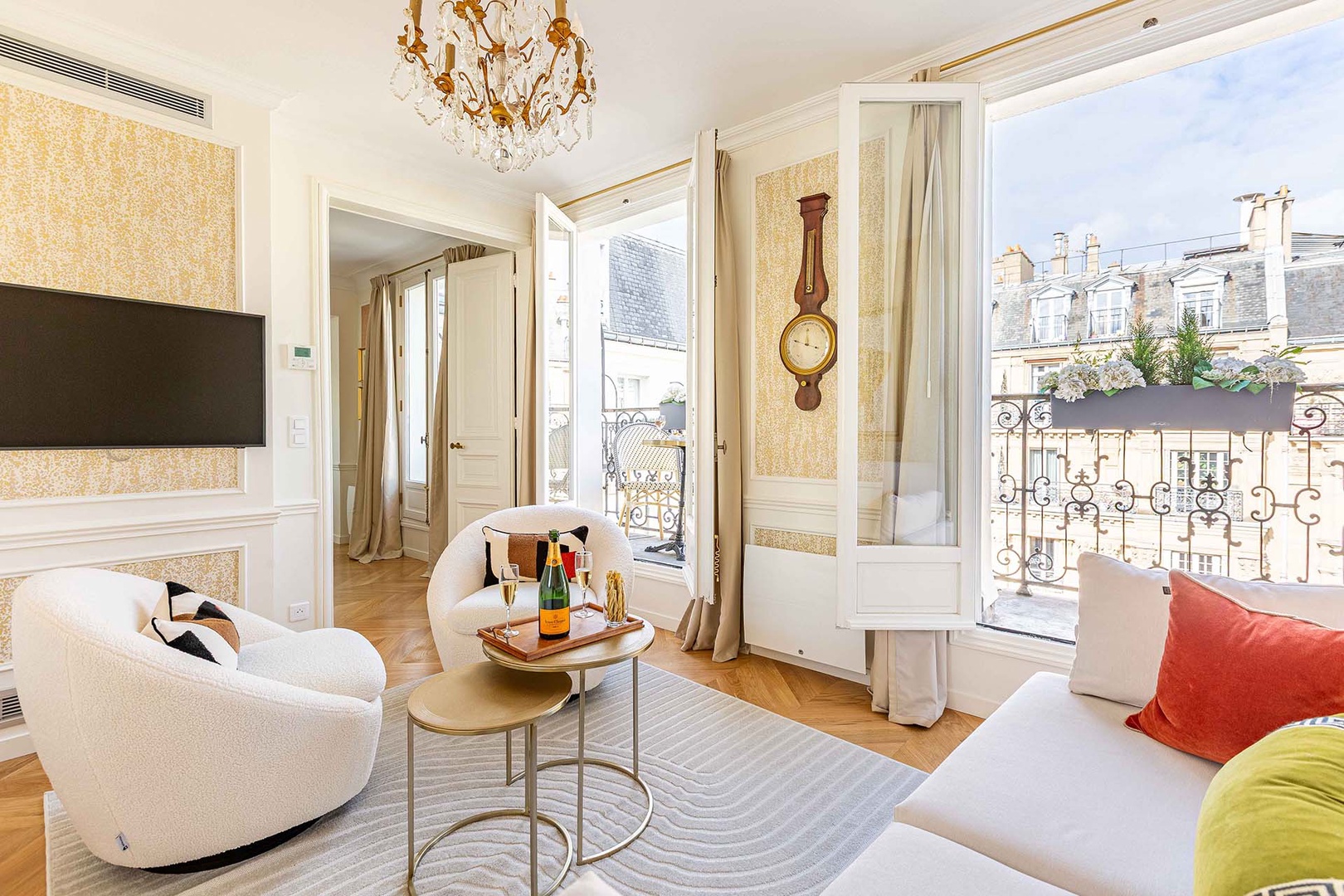 Lovely long balcony with bistro tables and glimpse of the Eiffel Tower.