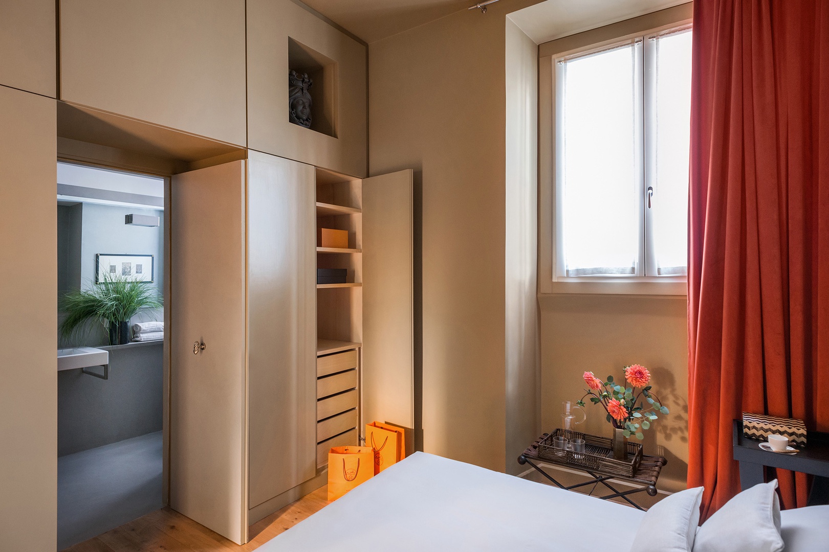 Bedroom view towards en suite bathroom. Internal facing window on the right.