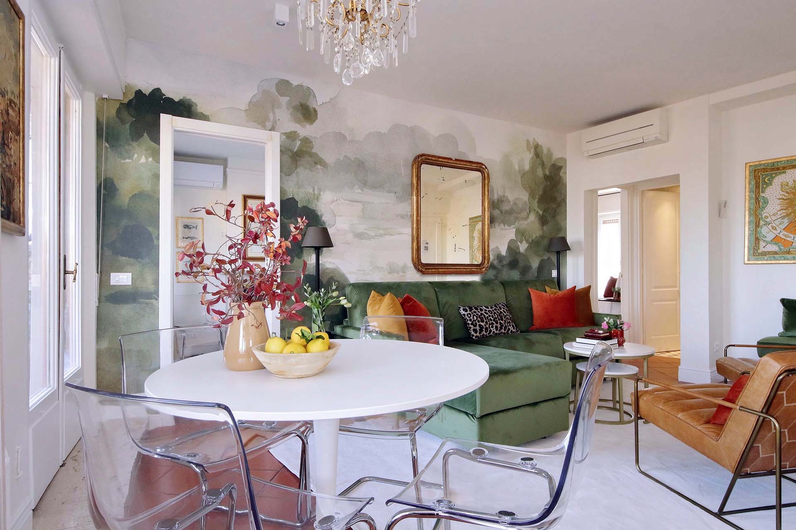 Elegant chandelier lighting, and comfortable seating perfect for dining and relaxing.