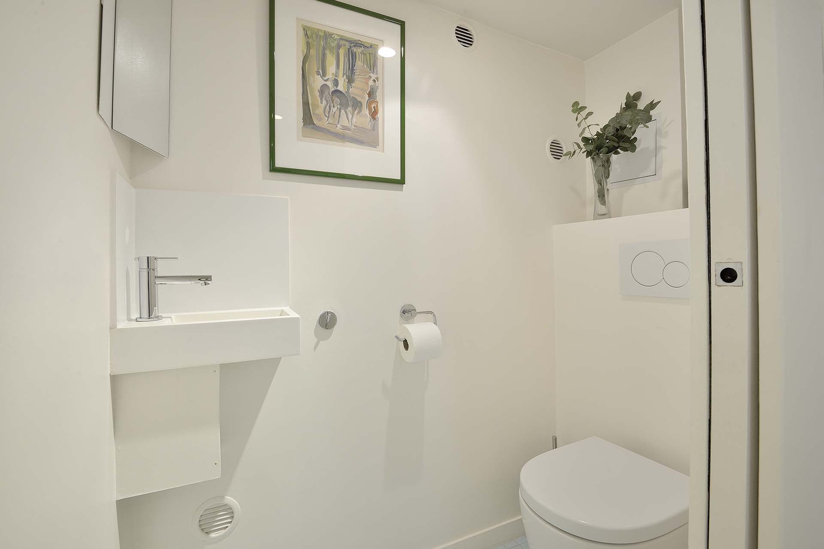 Powder room with toilet and sink.