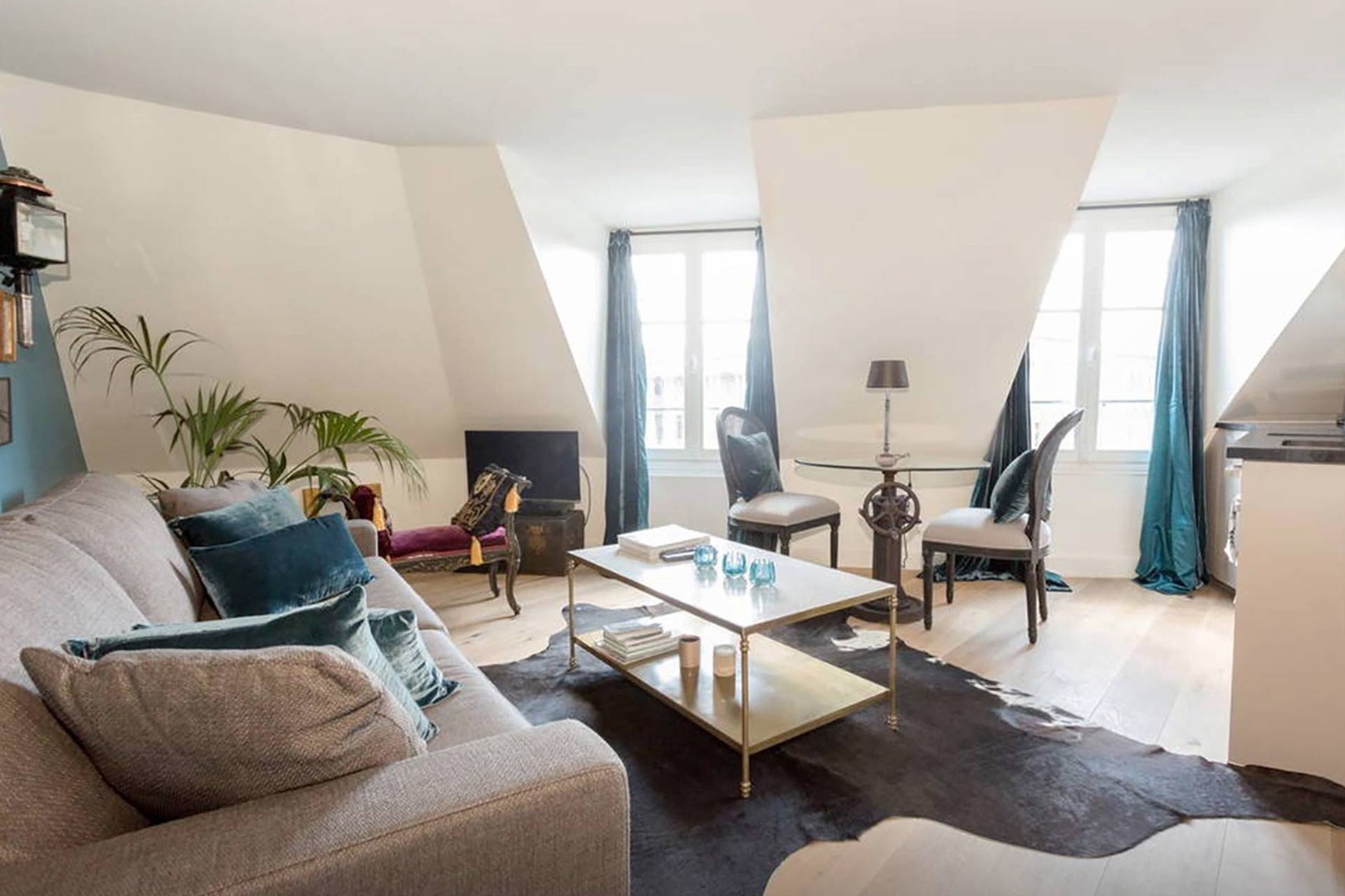 Open plan living room with Parisian dormer windows.