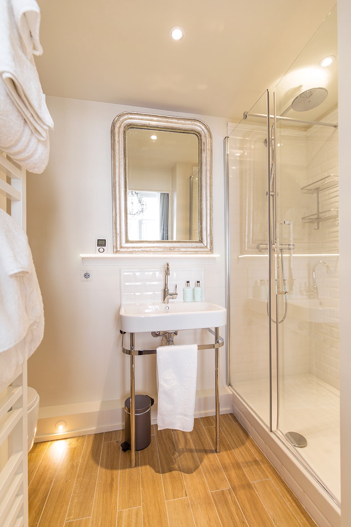 The large shower has a rainfall shower head.