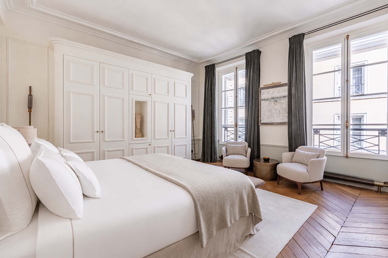 Soft colors and serene decor in bedroom 1.