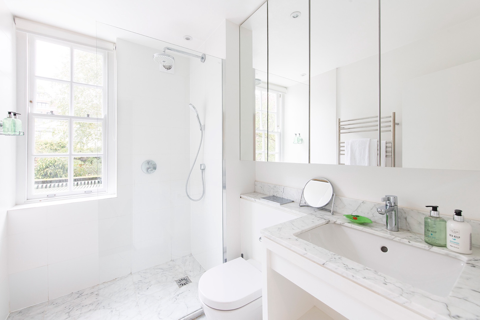 Gorgeous bathroom with large shower and beautiful light.