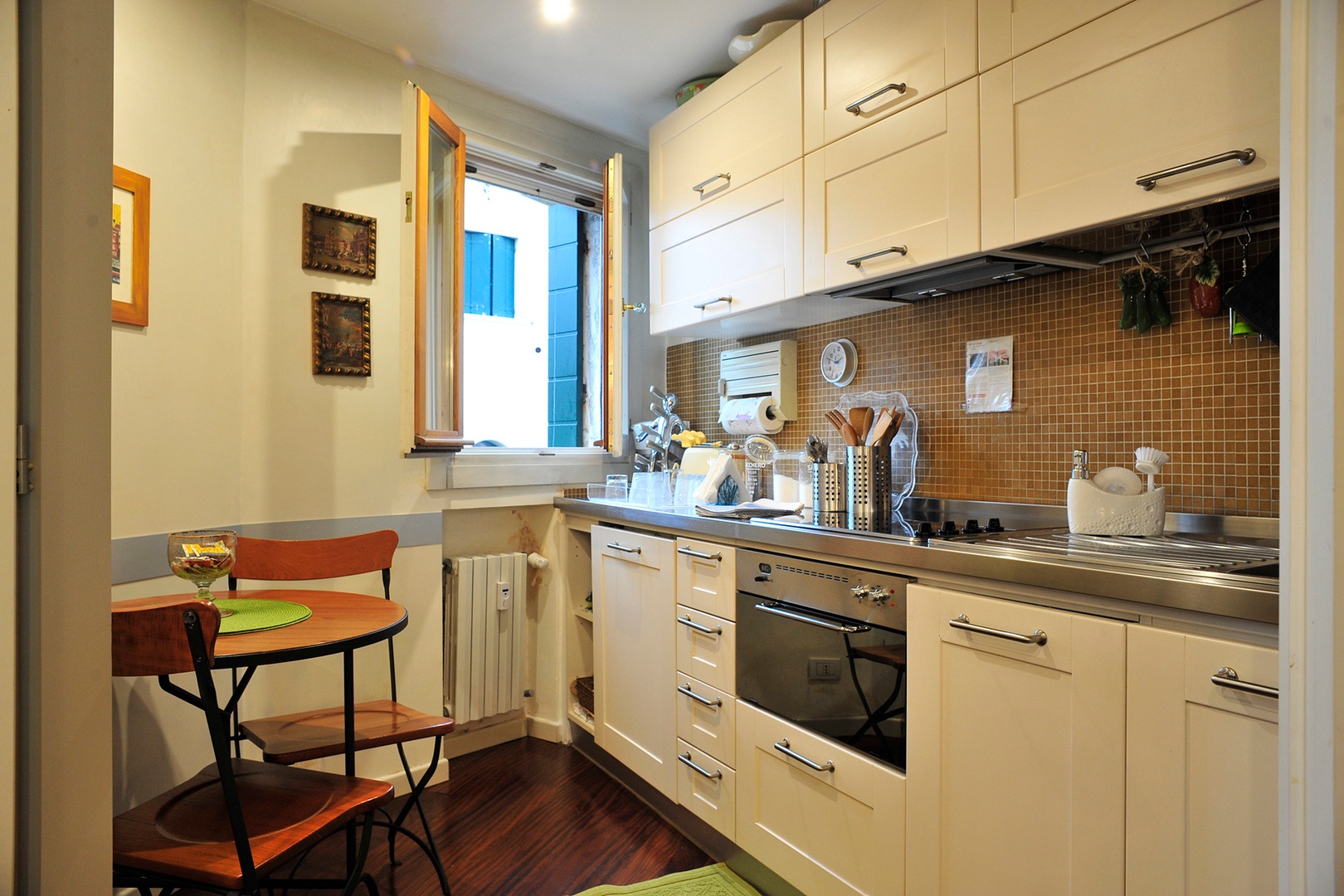 The small complete kitchen of Serenata has a breakfast table and pretty view out the window.