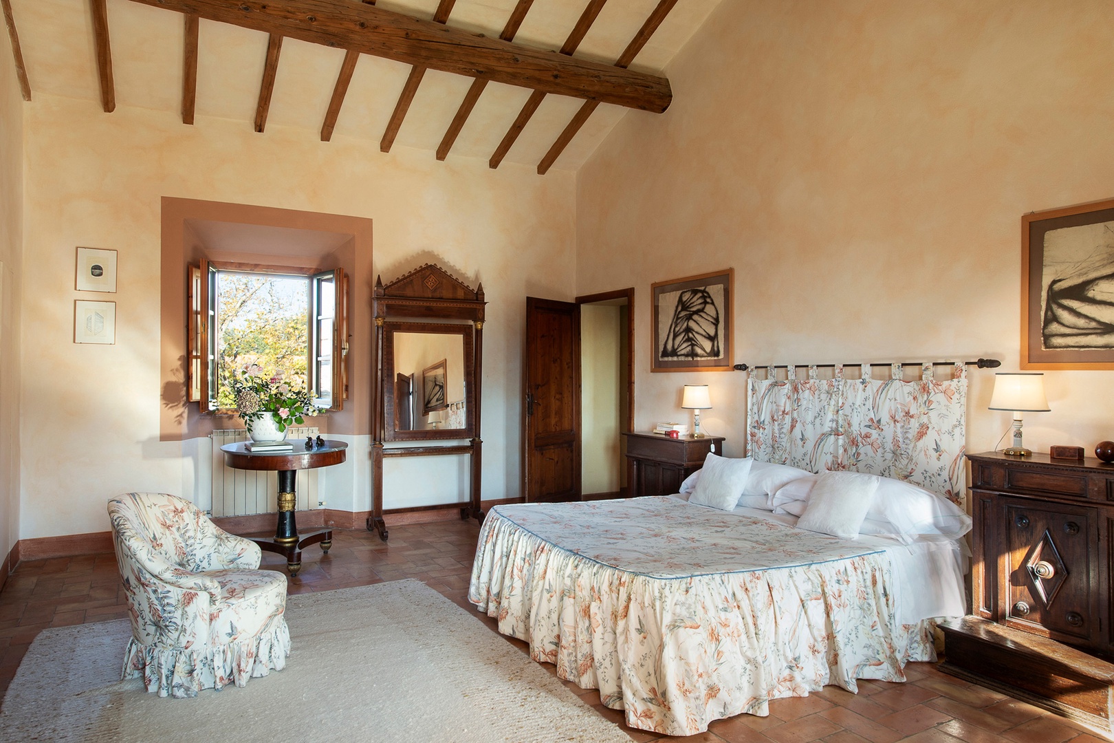 Restful bedroom with windows overlooking the garden and olive orchards to one side.