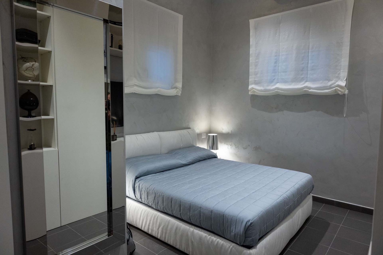 Serene bedroom decorated in cool grey tones.