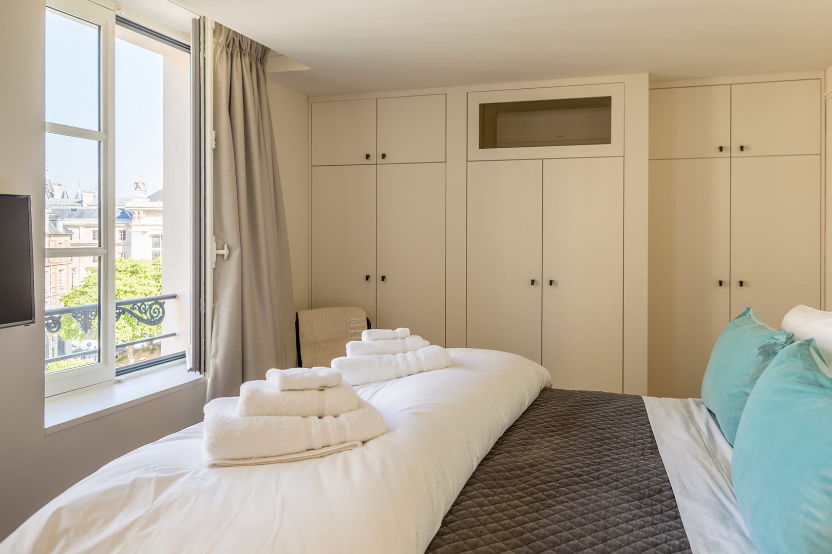 The bedroom overlooks Place Dauphine and has plenty of closets.
