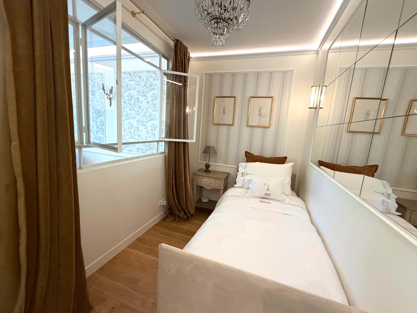 Bedroom 2 with single bed and clever window opening to living room.