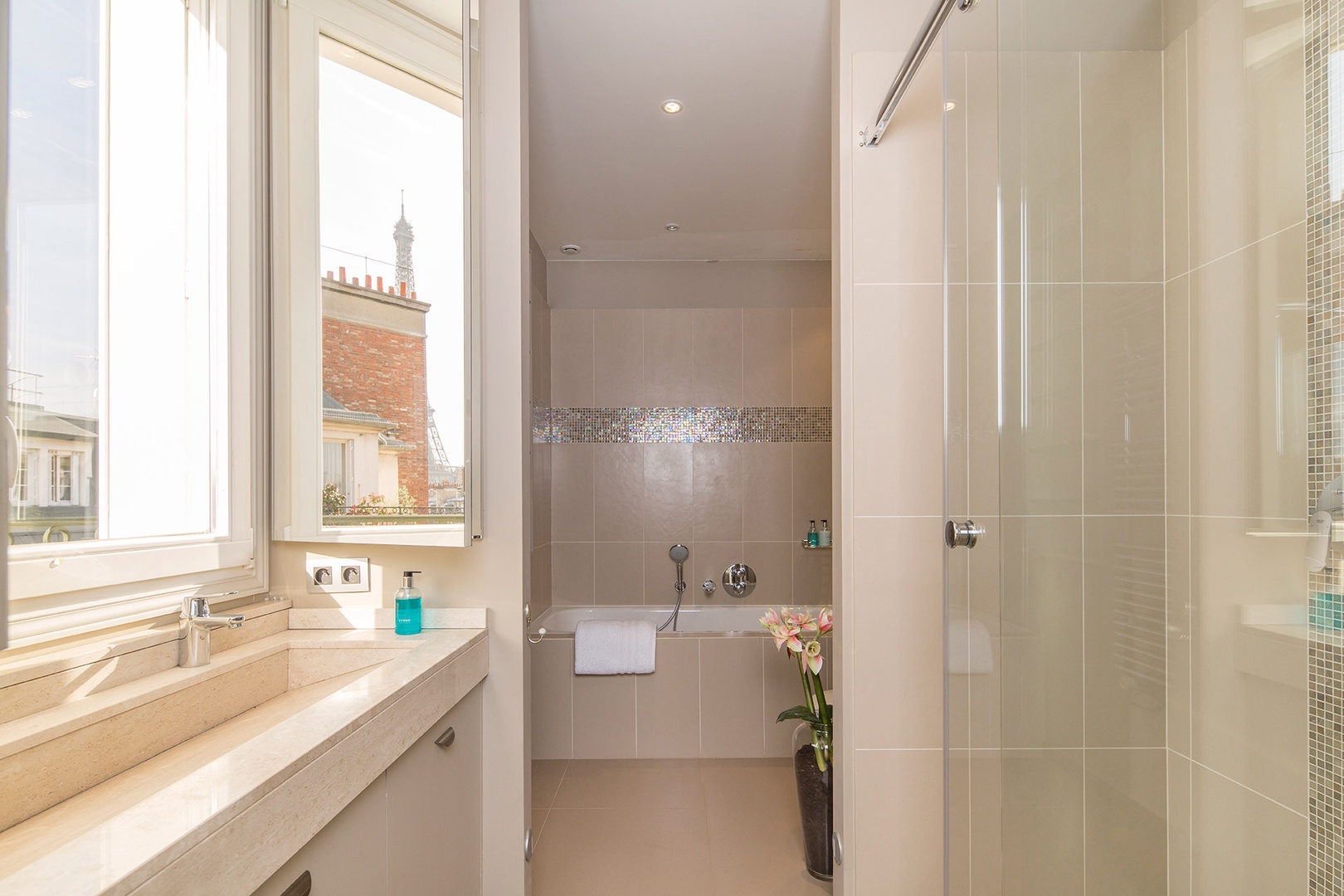 The luxurious en suite bathroom is equipped with a bathtub, shower, sink & toilet.