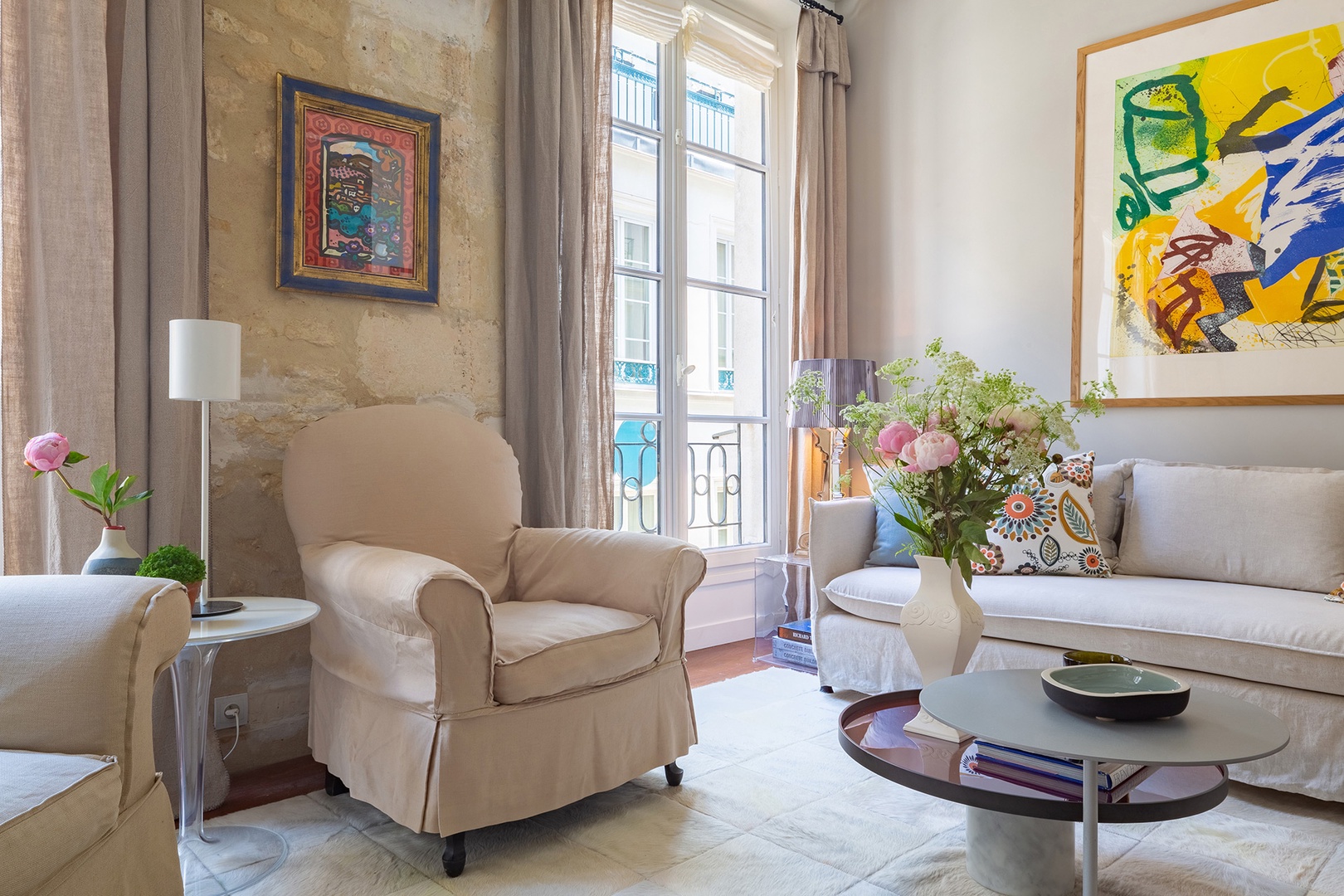 Sunlight fills the living room from two large windows.