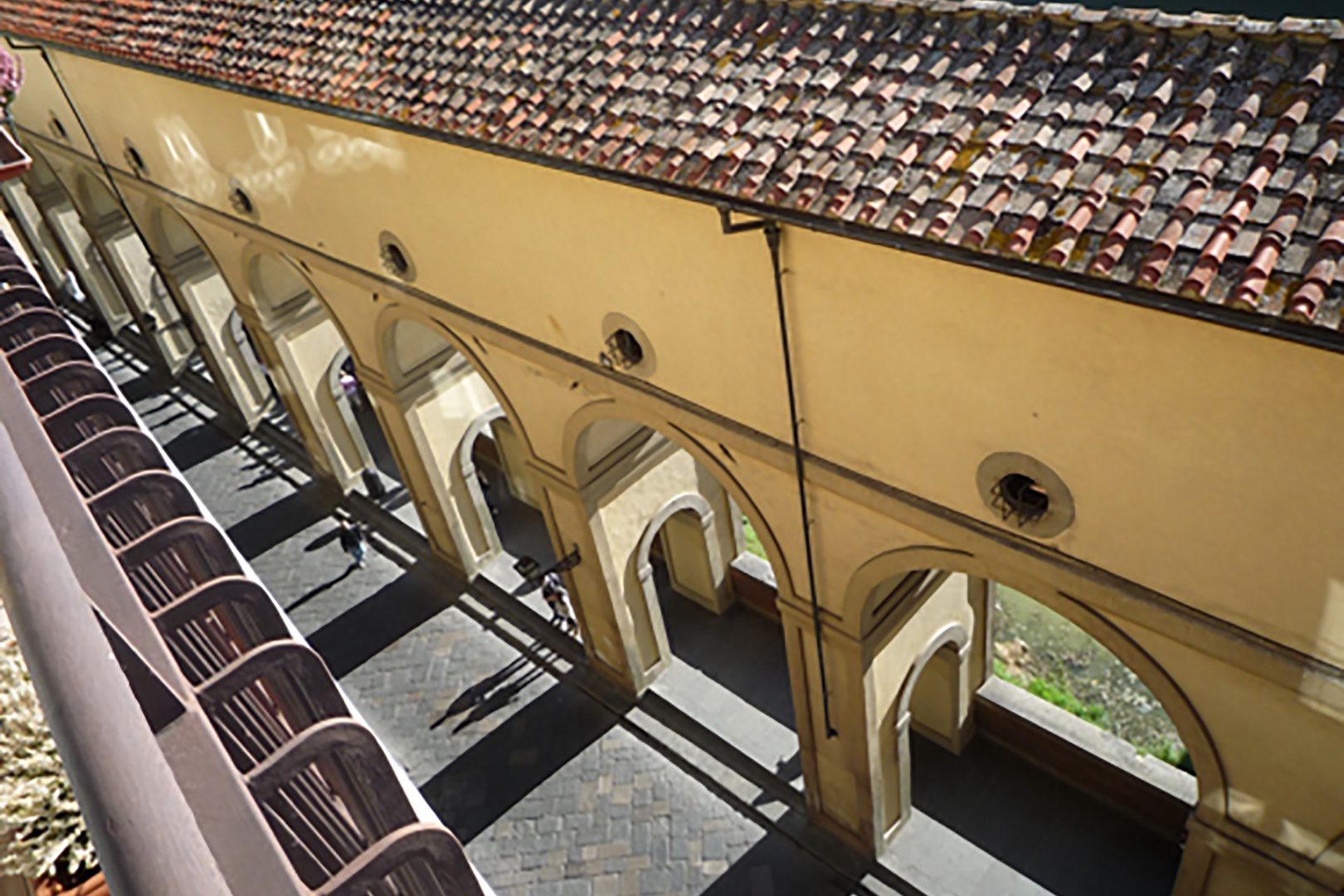 From the terrace you can see the arched walkway that runs along the Arno river.