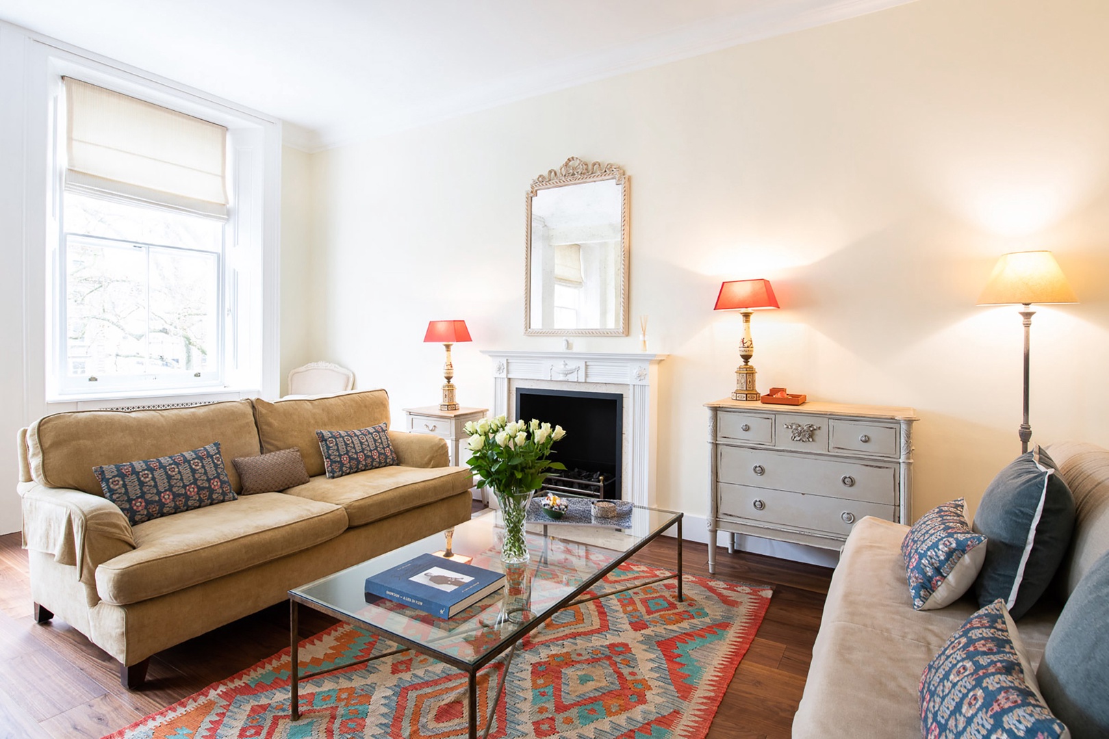 Light streams in three large windows in the living room.