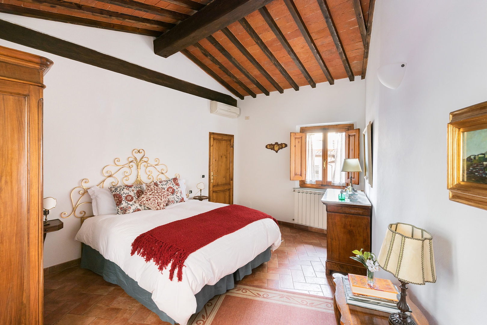 Impressive original beams in the bedroom rise high above the bed.