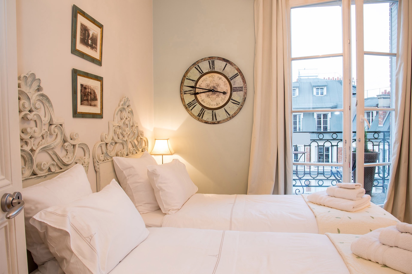 Sunshine streams through large windows into bedroom 3.