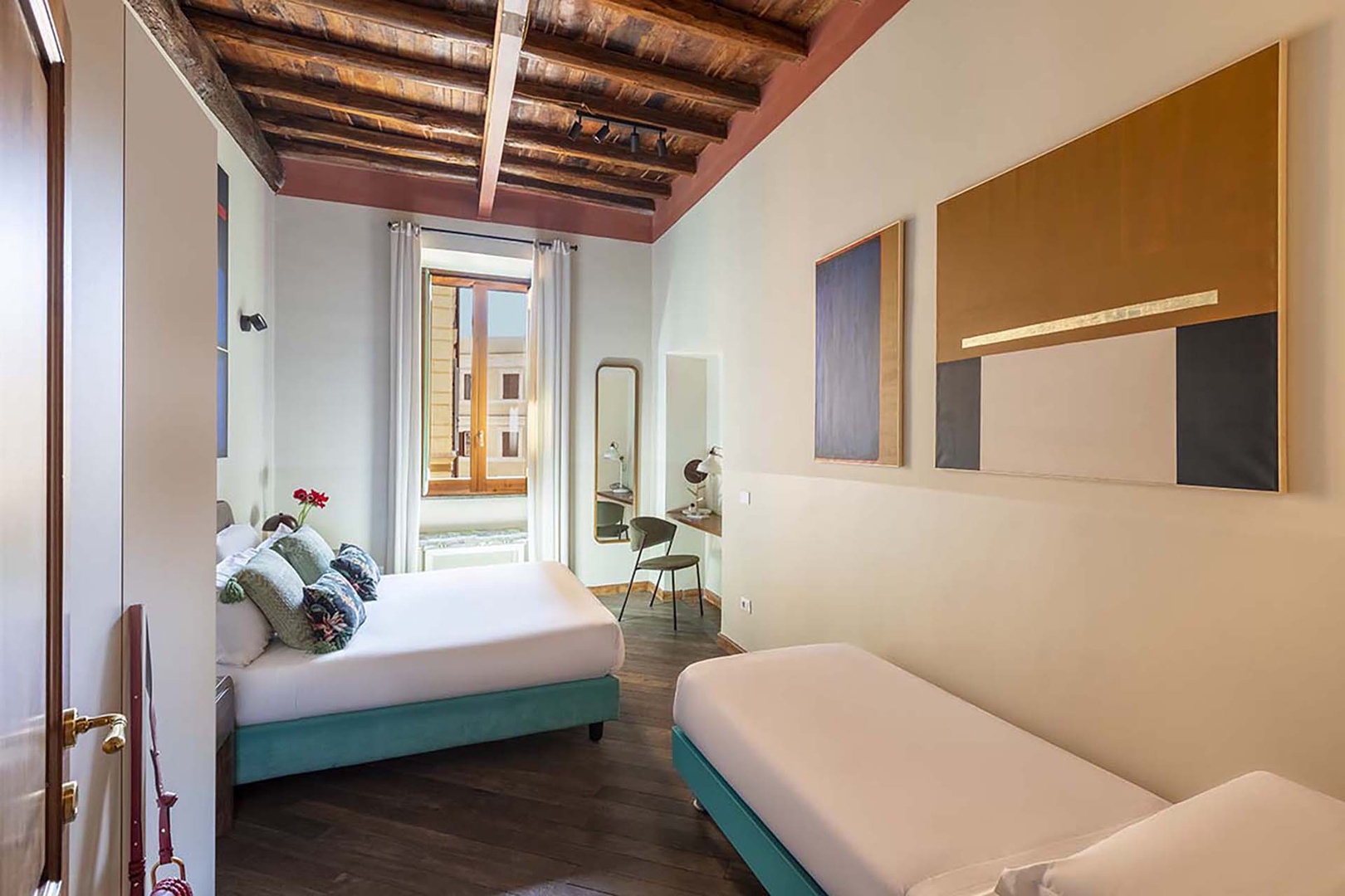 Bedroom 2 with rustic ceiling and large window.