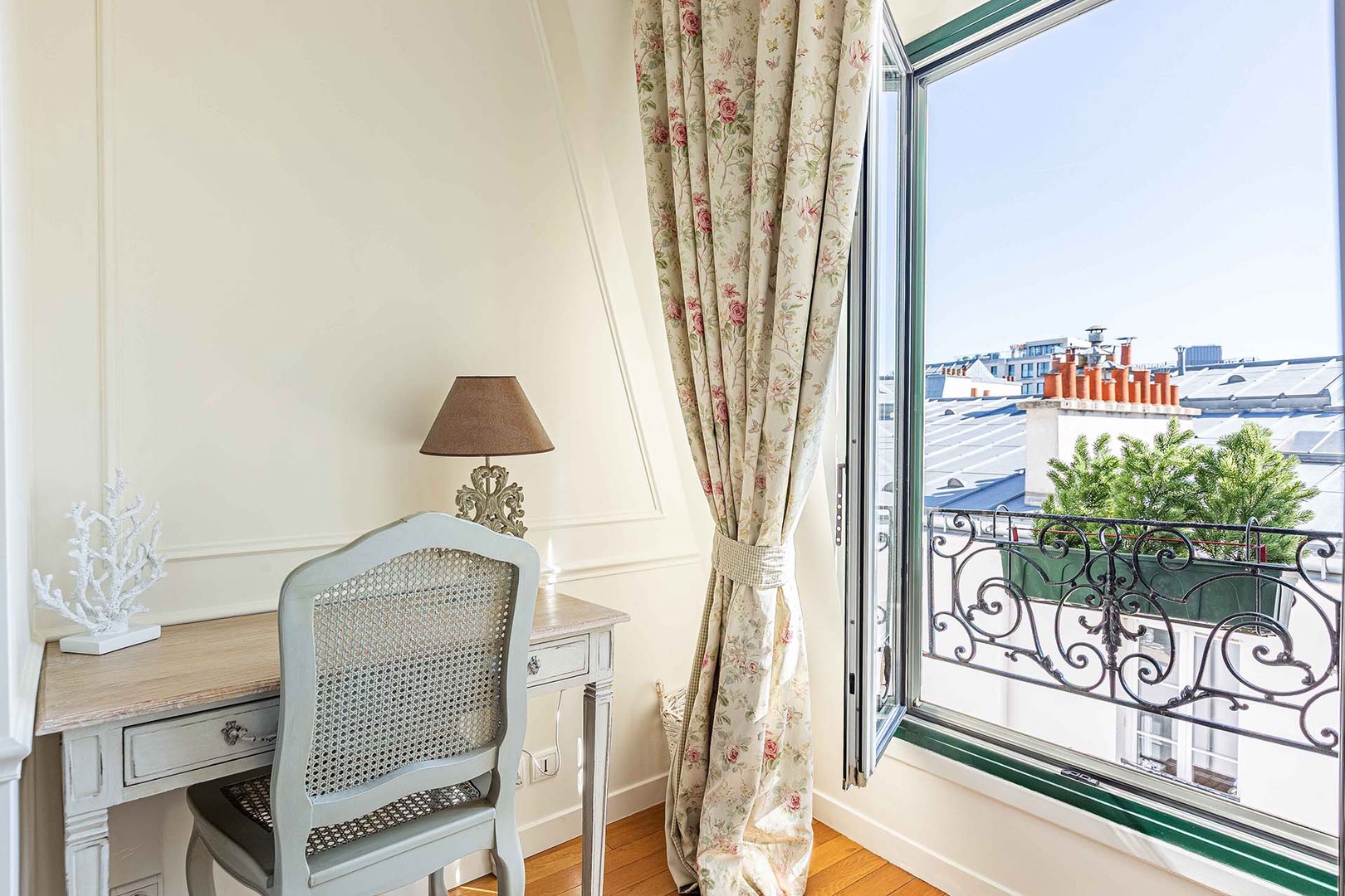 A charming workspace in the bedroom near the window.