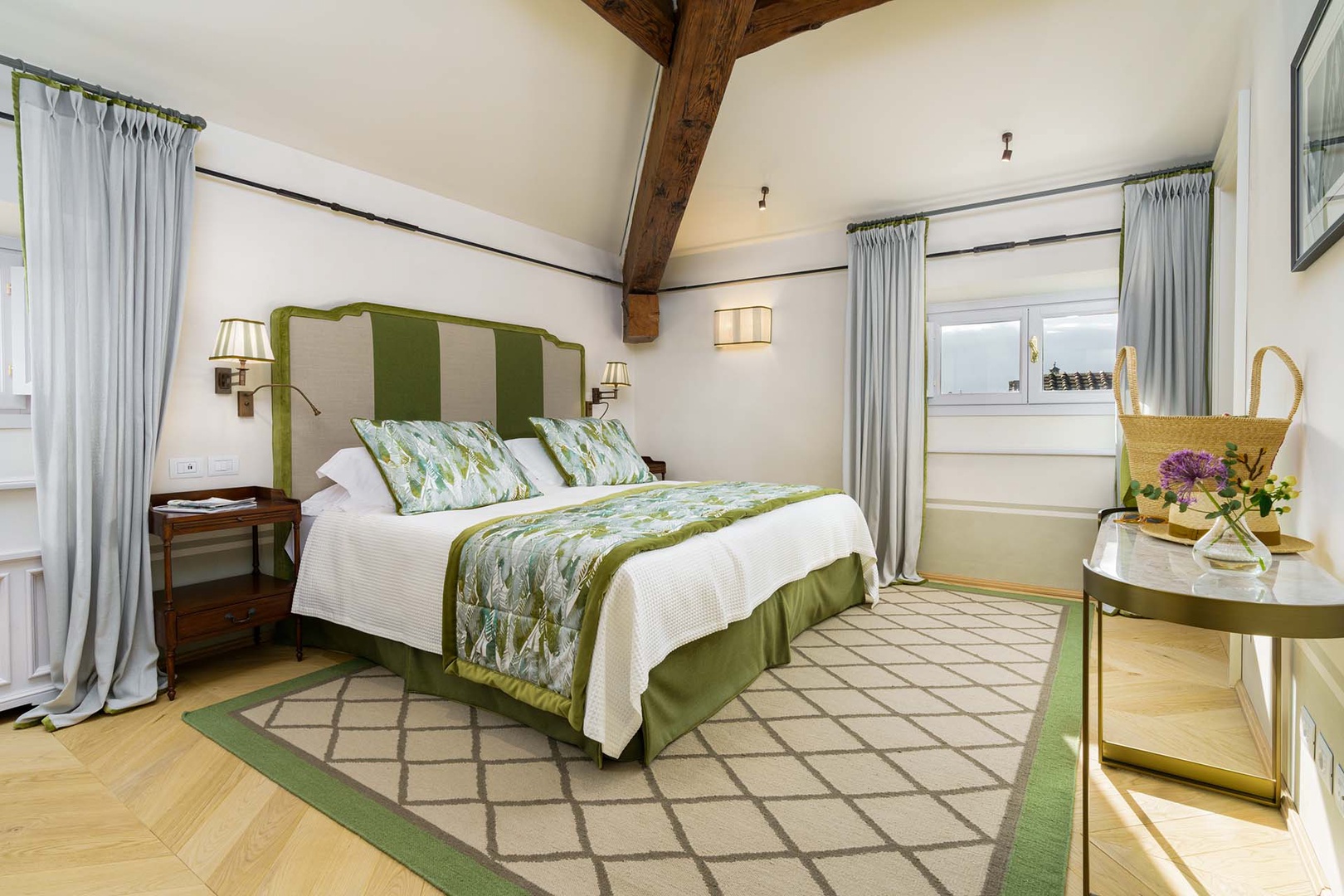Serene bedroom 1 with wooden beamed ceiling.