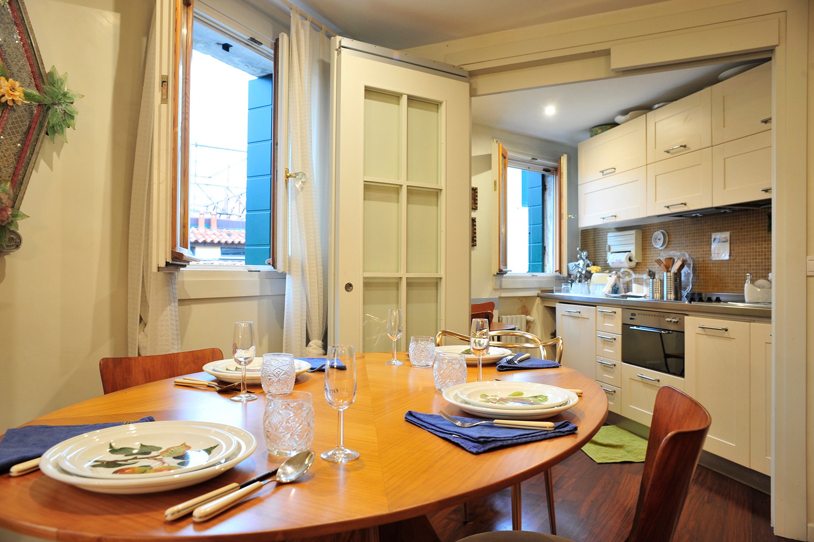 The dining room is lit by recessed lighting.