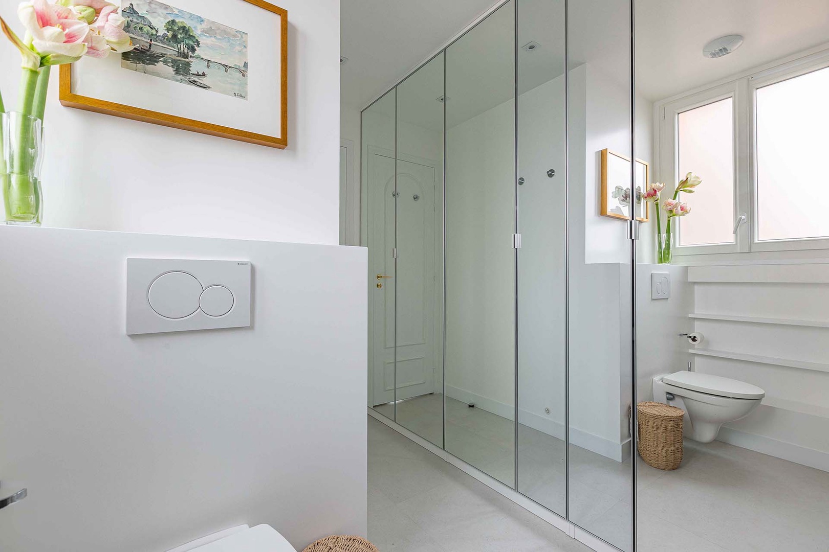Large mirrored storage in bathroom.