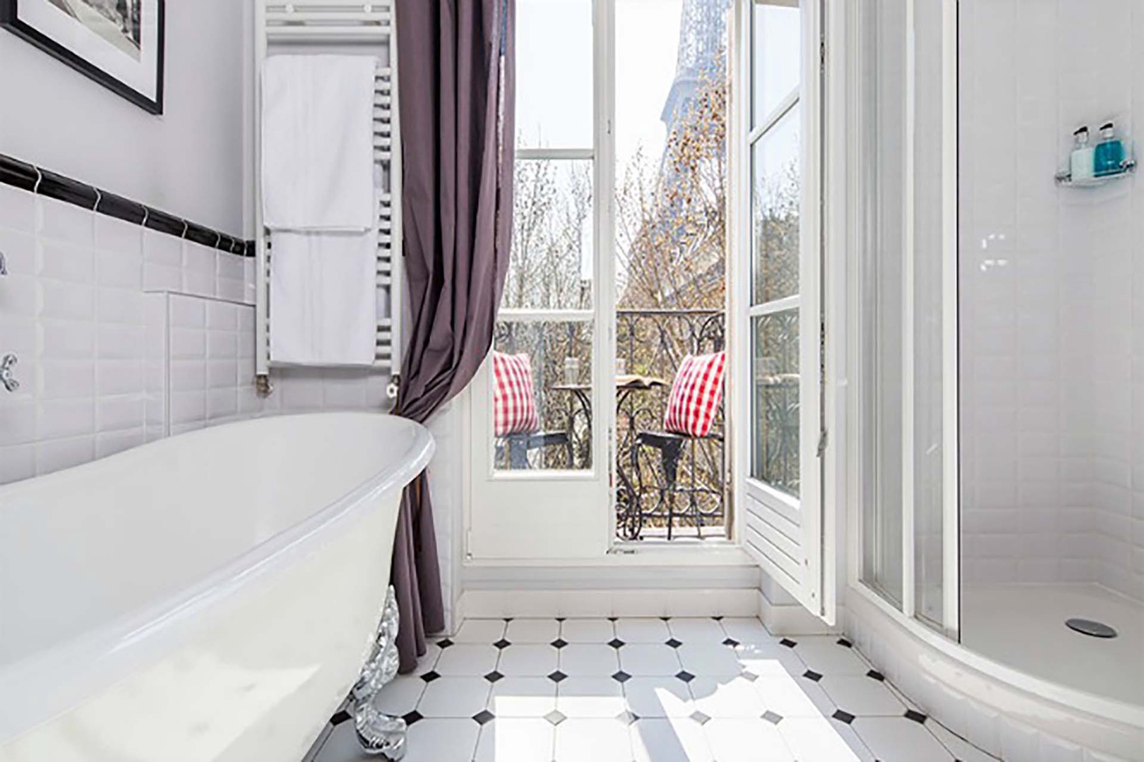 Look at this spectacular bathroom with claw foot tub and Eiffel Tower views!