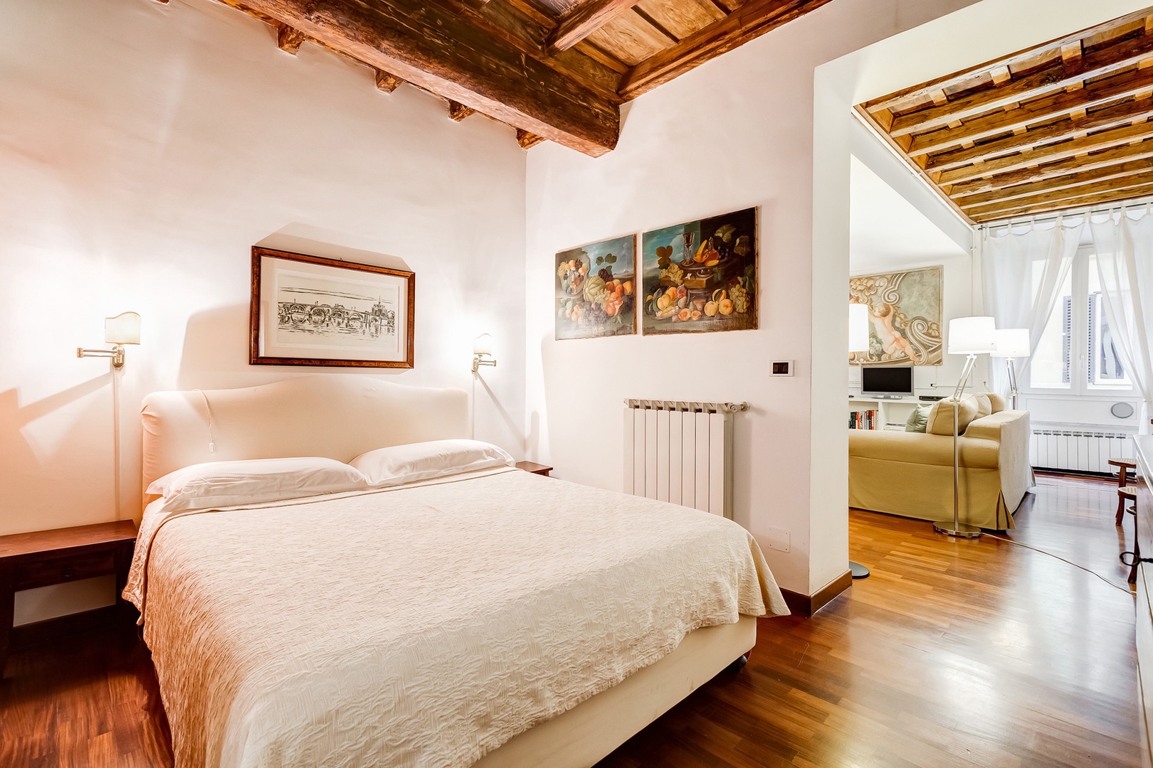 Comfortable bed with an etching of the Bridge of Angels over the Tiber river above it.