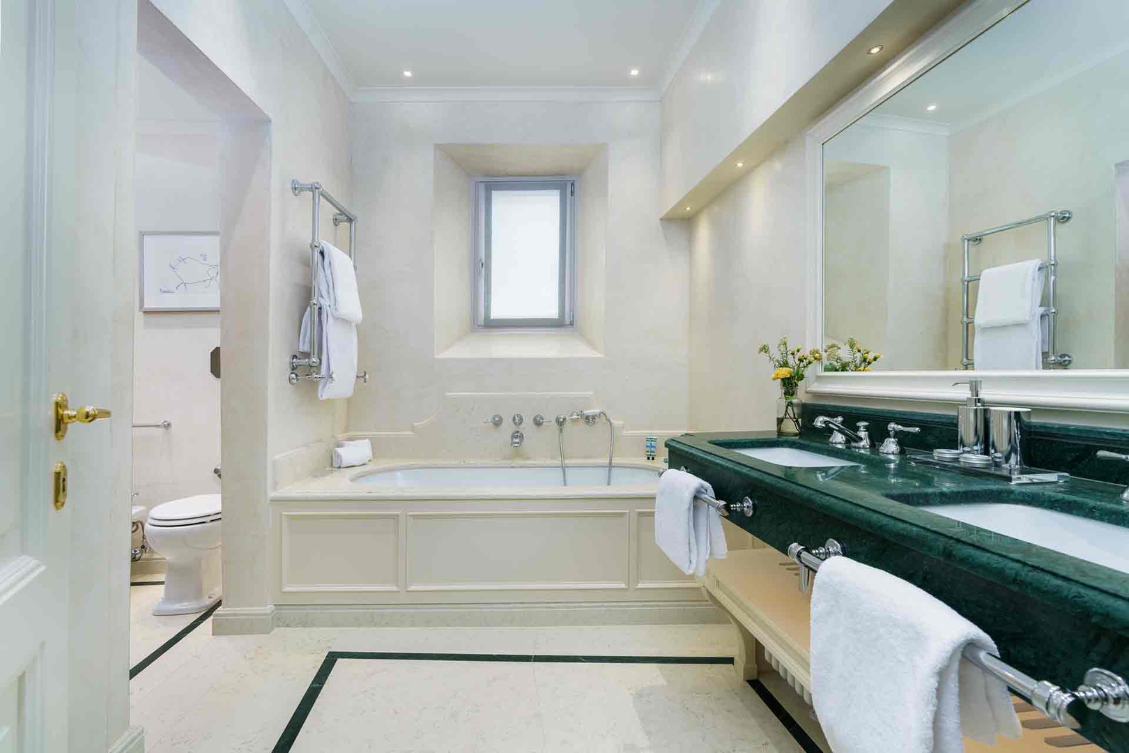 Sink into the deep soaking tub in bathroom 3 after a day of exploring