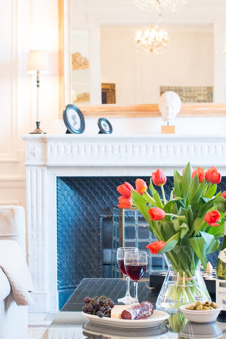 The marble fireplace is the focal point for the living room.