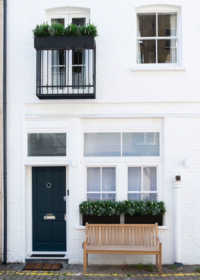 Charming mews entrance and decorative balcony.
