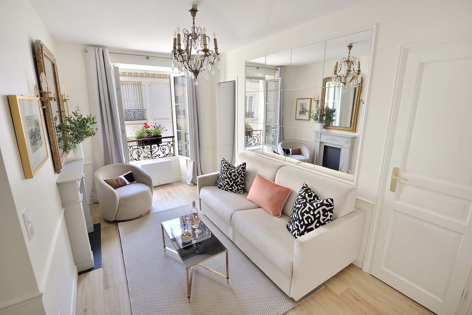 Large window and mirrors fill the room with light.