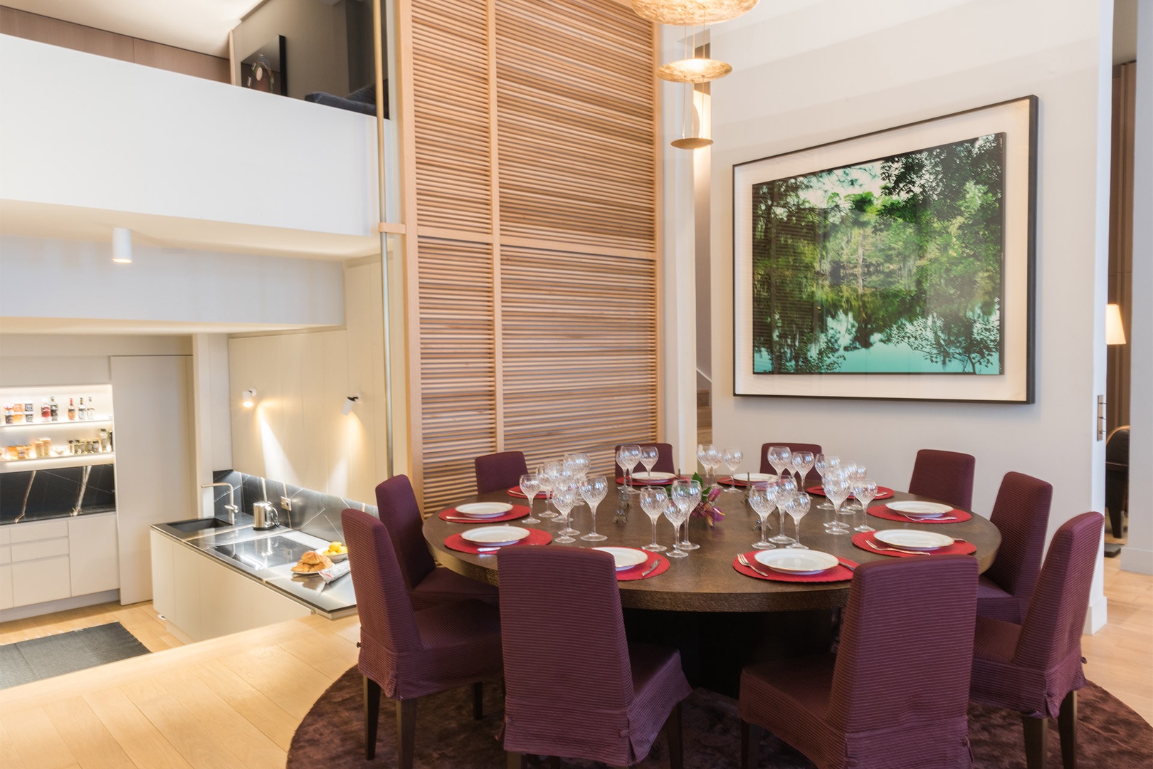 The centerpiece of the room is a grand dining table that seats up to 10 people.