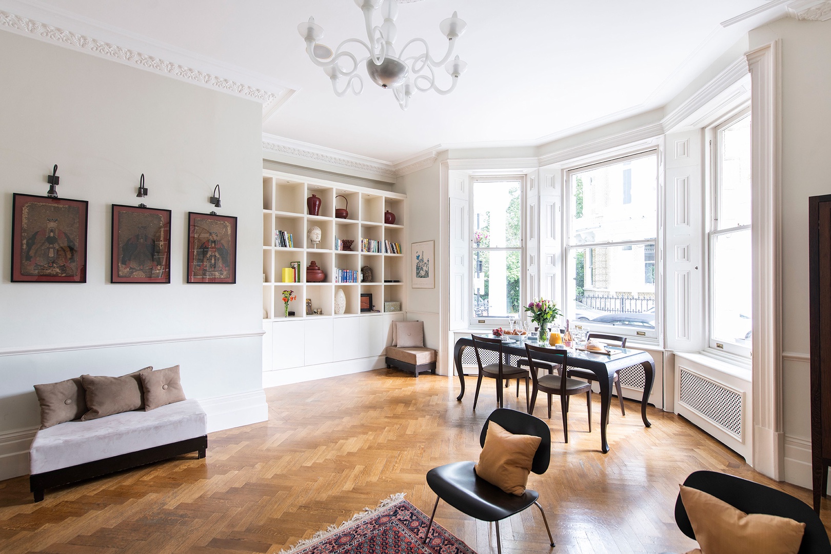 Light from the large bay windows fills the apartment.