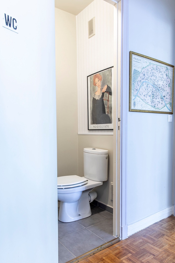 Separate half bath with toilet next to the bathroom.