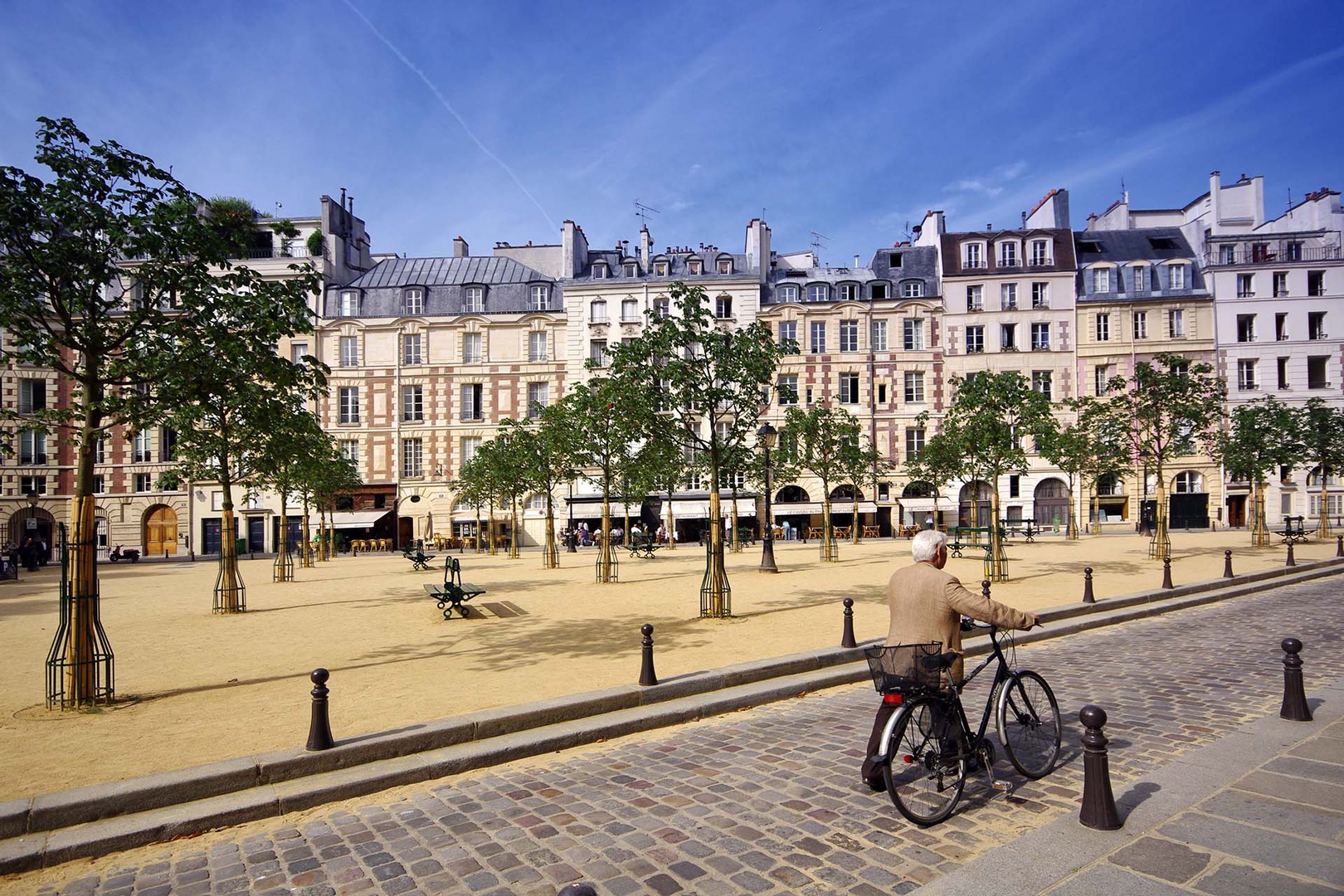 Step outside right on Place Dauphine, lined with historic buildings.