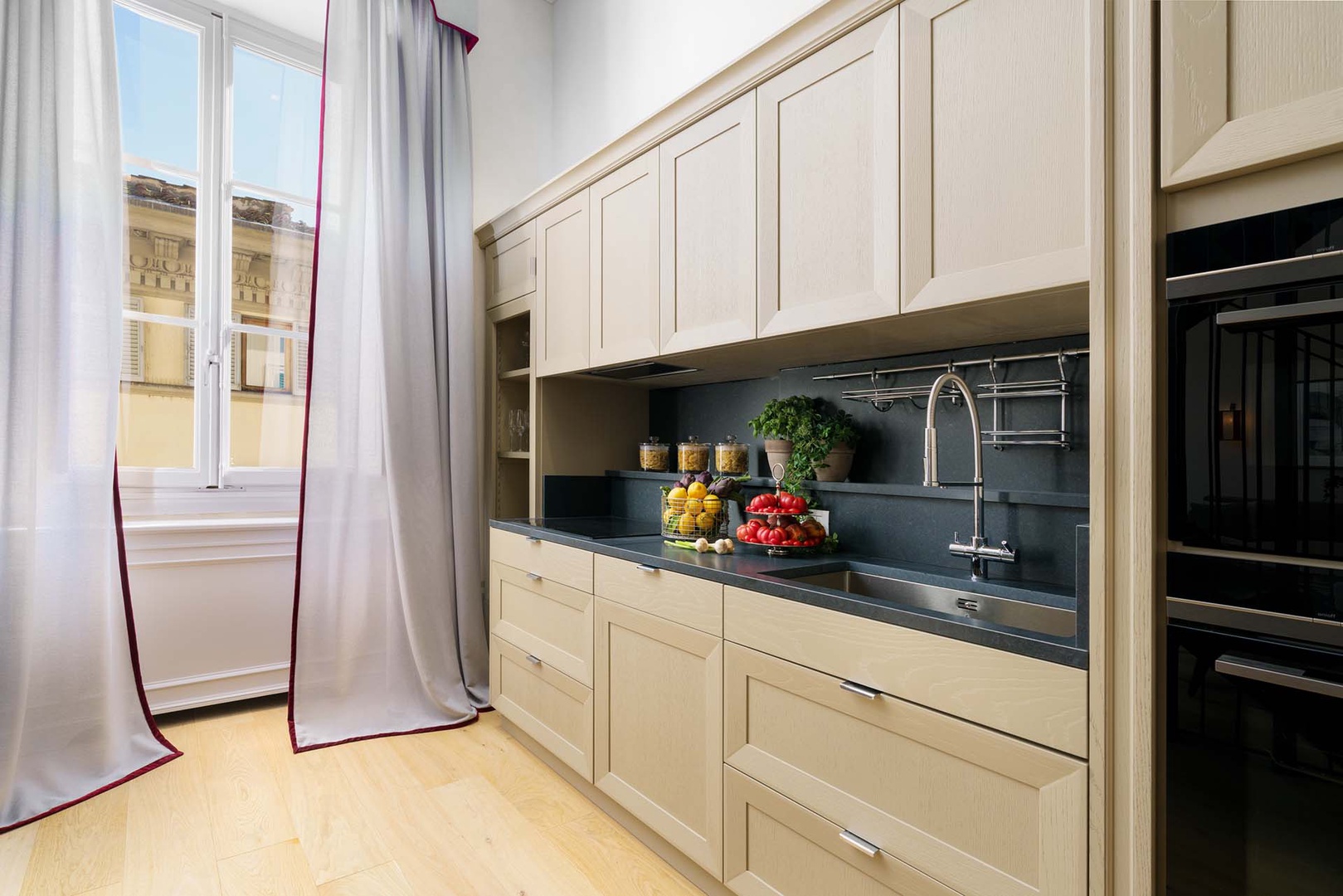 Fully equipped kitchen is conveniently located in open plan living area.