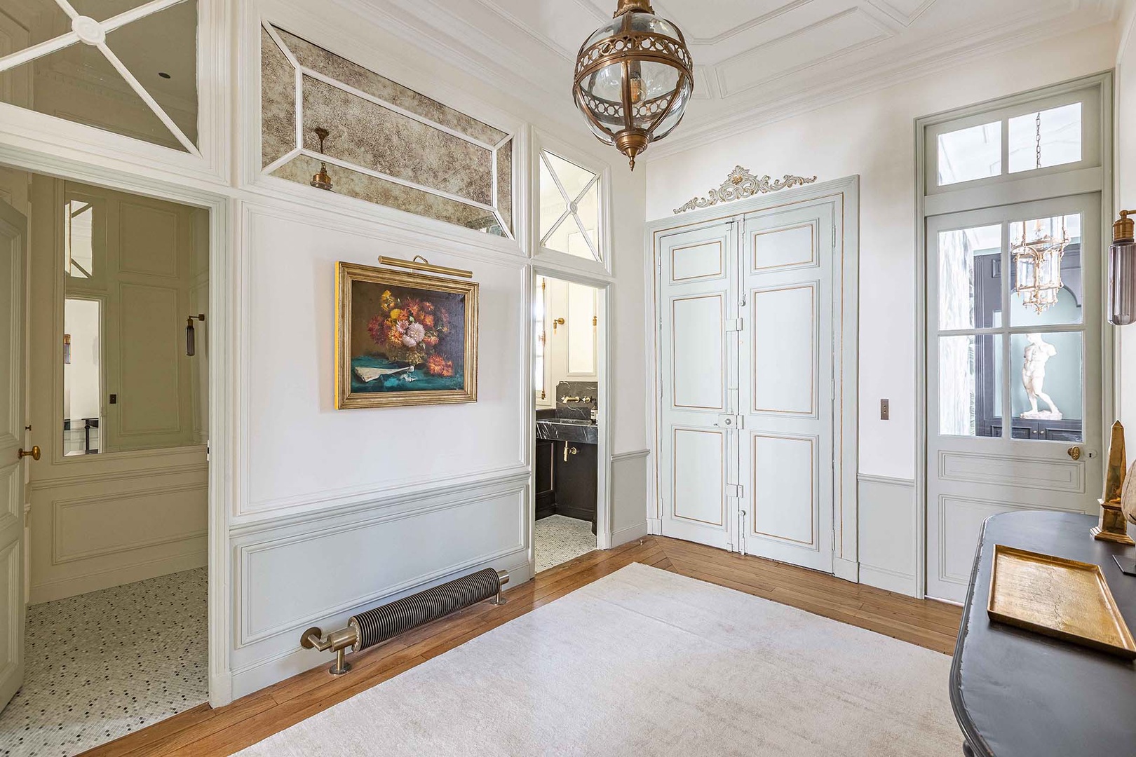 Grand entrance hallway with additional bathroom.