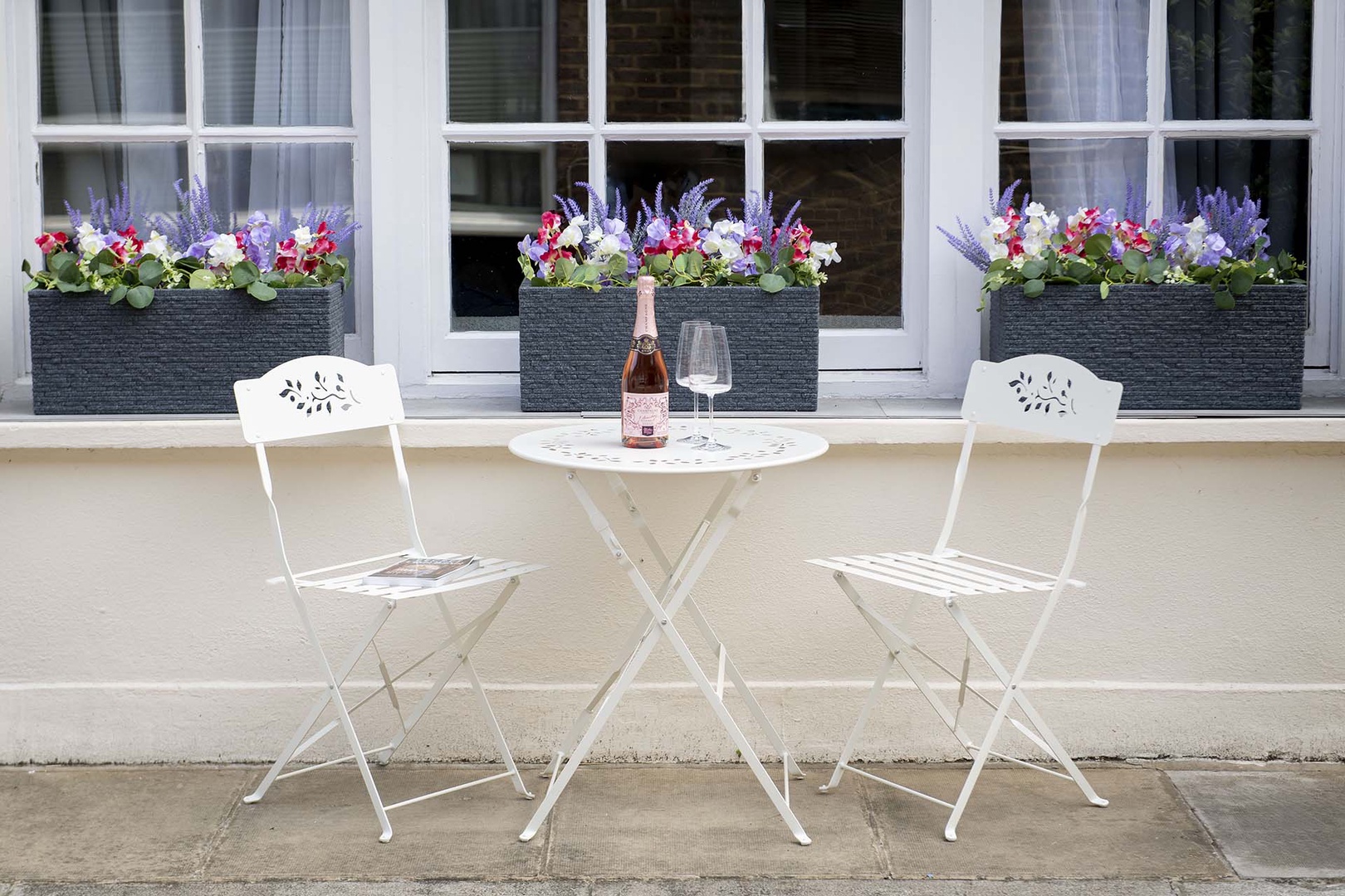 Bistro table located by front entrance on the mews.