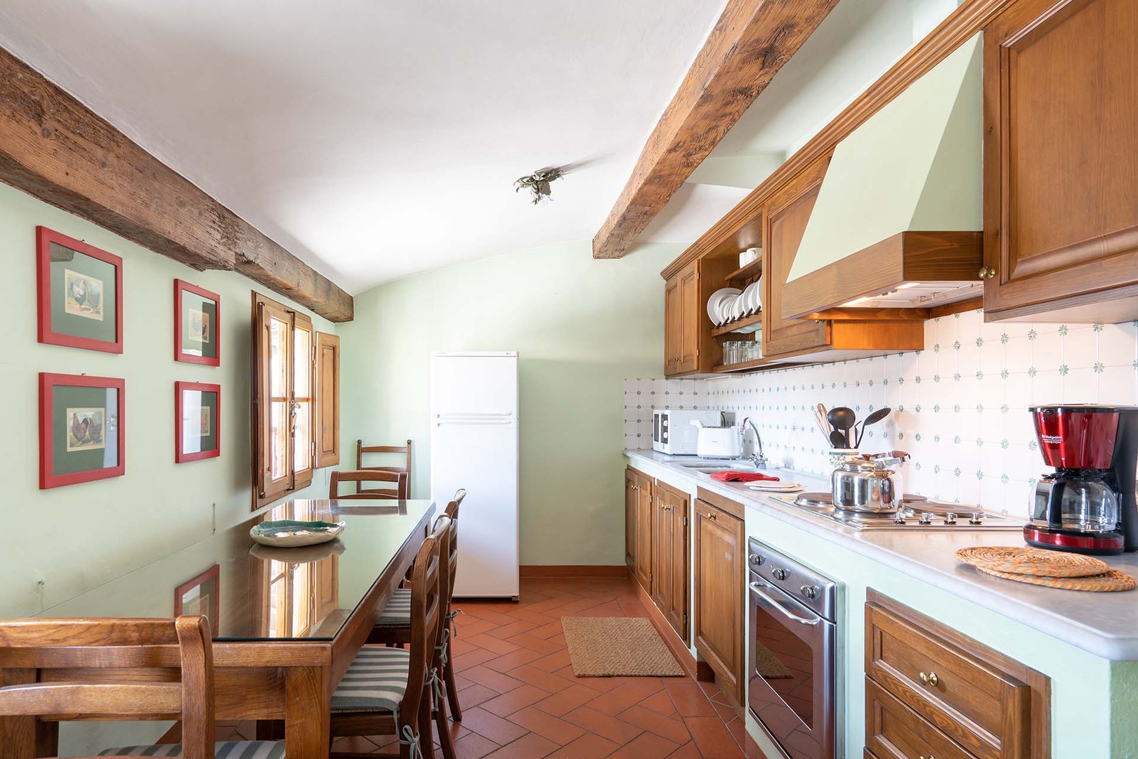 Fully equiped kitchen and eat in dining area with views of the bustling piazza below.